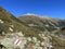 Alpine mountaineering signposts and markings in the mountainous area of the Albula Alps and above the mountain road pass Fluela