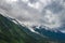 Alpine mountains and Chamonix valley under cloudy sky