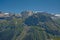 Alpine mountains with forest and granite tops with snow, France