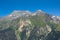 Alpine mountains with forest and granite tops with snow, France