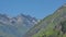 Alpine mountains and valley with forest and granite tops with snow, France