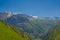 Alpine mountains and valley with forest and granite tops with snow, France