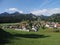 Alpine panorama with houses and modern train at european Gruyeres town in Switzerland on August