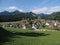 Alpine panorama with houses and train at european Gruyeres town in Switzerland on August