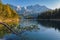 Alpine panorama of Lake Eibsee with Germanys highest mountain Zugspitze in the background on a sunny afternoon in autumn