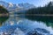 Alpine panorama of Lake Eibsee with Germanys highest mountain Zugspitze in the background on a sunny afternoon in autumn