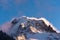 Alpine peak in winter with storm clouds building behind