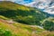 Alpine road with serpentines and alpine flowers, Furka pass, Switzerland