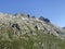 Alpine rocky peak Pizzo della Valletta 2726 m above the reservoir lake Lago di Lucendro in the Swiss mountain area