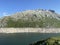 Alpine rocky peak Pizzo della Valletta 2726 m above the reservoir lake Lago di Lucendro in the Swiss mountain area