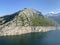 Alpine rocky peak Pizzo della Valletta 2726 m above the reservoir lake Lago di Lucendro in the Swiss mountain area