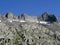 Alpine rocky peak Pizzo della Valletta 2726 m above the reservoir lake Lago di Lucendro in the Swiss mountain area