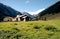 Alpine rural scene seen from a rocky ridge. Hiking in Swiss Alps.