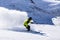 Alpine skier on piste, skiing downhill