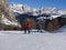 Alpine Skiers Descending a Beautiful Snowy Slope and a view of the Beautiful Surrounding Landscape of the Snow-covered of the