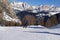 Alpine Skiers Descending a Beautiful Snowy Slope and a view of the Beautiful Surrounding Landscape of the Snow-covered of the