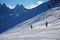 Alpine skiers embrace the stunning snowy backdrop of the mountain range