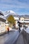 Alpine skiers walking on street St. Johann in Tirol