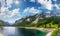 Alpine summer lake sunshiny panorama.