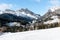 Alpine village in a majestic snowy mountain setting in winter