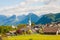 Alpine village St. Gilgen with a church, mountains on background