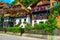 Alpine village street with flowery wooden houses, Hallstatt, Salzkammergut, Austria