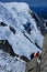 Alpinist climbing Aiguille du Midi at 3842m, Mont Blanc massif