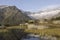 Alpinist makes a break during a sunrise at a mountain lake in the alps