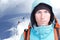 Alpinist man with a backpack on a background of mountain scenery. Looking at the camera.