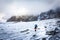 Alpinist moutaineer walking glacier towards rock cliffs