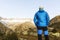 Alpinist stands during the dawn of dawn in front of the alps