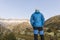 Alpinist stands during the dawn of dawn in front of the mighty mountain scenery