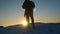 Alpinist travels hiking. a traveler climbs a snowy mountain, tourists meet on a hilltop in the sunset light. tourist