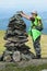 Alpinist woman making stone pile