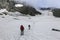 Alpinists on a snowy route surrounded by rocky mountains in the fog in Austrian Alps near the Grossglockner rock summit, Kals am