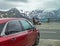 Alps, Austria â€“ July 27, 2017:: Family resting in Alps Austria. Red car for traveling is standing near.
