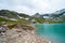 Alps landscape - glacial lake in front of mountains and blue sky