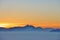 The alps over a layer of high fog in sunset. Austria, Europe.