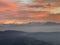 Alps Panorama in winter at sunset with fog an hills in the foreground. The view from Uetliber, Zurich Switzerland