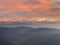 Alps Panorama in winter at sunset with a layer of fog an hills in the foreground. The view from Uetliber, Zurich Switzerland