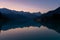 Alps silhouette in reflection in the lake Barcis