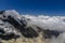 Alps snow ridges above the clouds