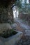 Alpujarra stone fountain located at the beginning of a street slope along the route through Taha de Pitres in autumn