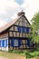 Alsatian frame house with a stork`s nest on the roof