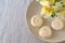 Alstroemeria flowers with plate cakes on white tablecloth background.