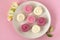 Alstroemeria flowers with plate cakes on white tablecloth background.