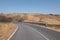 Alta Irpienia, windy hills in full sun. Summer, wheat fields, asphalt ribbon curving towards the sky. Italy, Campania