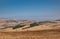 Alta Irpienia, windy hills in full sun. Summer, wheat fields, asphalt ribbon curving towards the sky. Italy, Campania