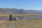 Altai, Mongolia - June 11, 2017: Motorcycle traveler man in helmet riding a motorbike in the steppes of Mongolia