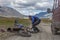 Altai, Mongolia - June 14, 2017: Male tourist is repairing a motorcycle. The nature of Mongolia